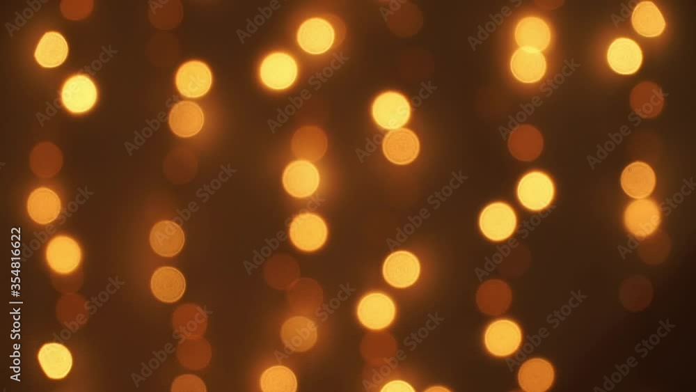 Abstract blurred sparkling light of golden garland. Christmas and New Year bokeh background. Fast and slow flickering of lights Abstract blurred sparkling light of golden garland. Christmas and New Year bokeh background. Fast and slow flickering of lights