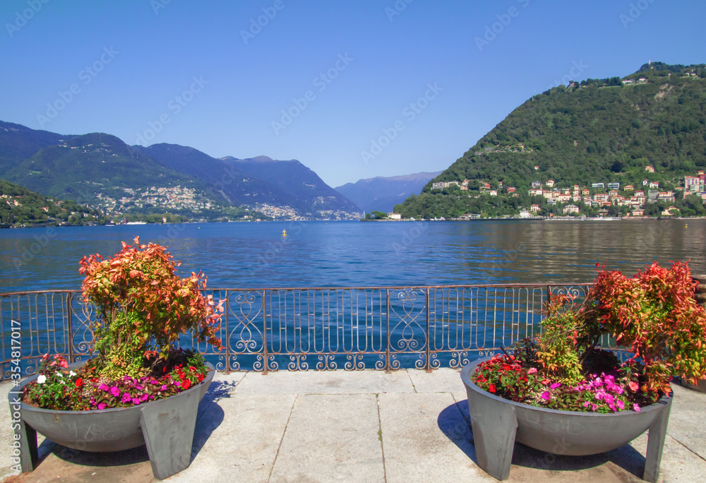 Como - Italy. panoramic view of Como Lake from a terrace with flower pots