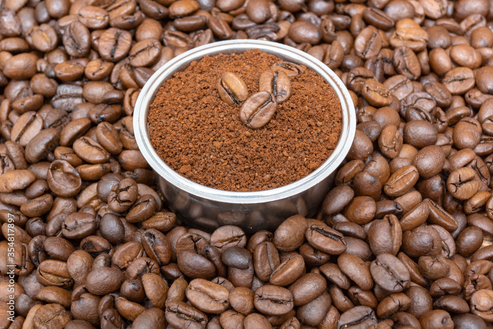 Coffee beans and ground coffee sprinkled with a slide An example for making in a coffee maker Coffee beans and ground coffee sprinkled with a slide An example for making in a coffee maker