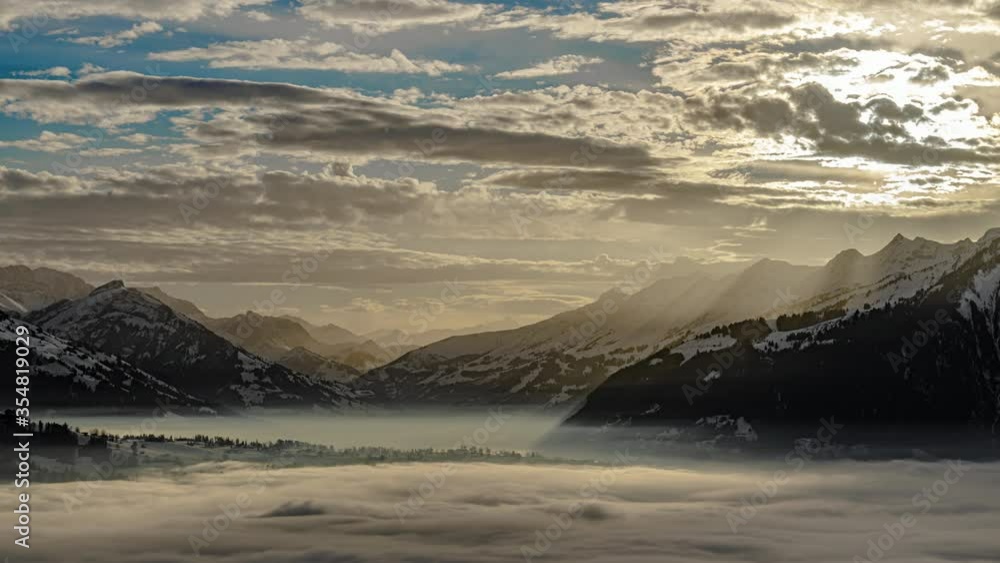 Time lapse at the sunset with a sea of clouds with snowy mountains in the background. Time lapse at the sunset with a sea of clouds with snowy mountains in the background.