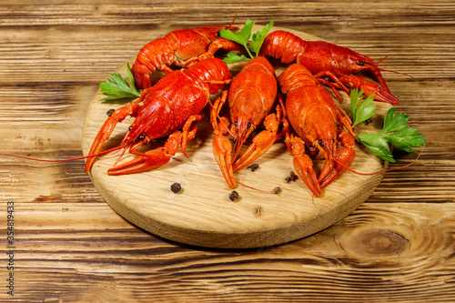 Boiled crayfish on cutting board on wooden table