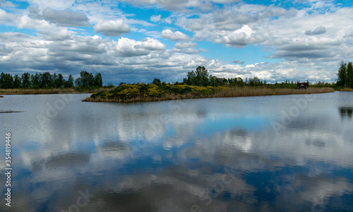 calm scene of beautiful sky with cumulus clouds reflection on the lake