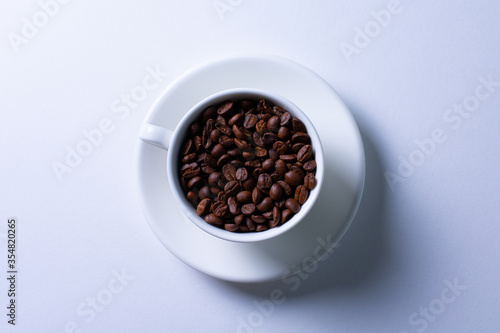 coffee beans in a white mug on a white background