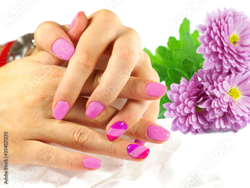 Beautiful purple manicure with flowers on white background 