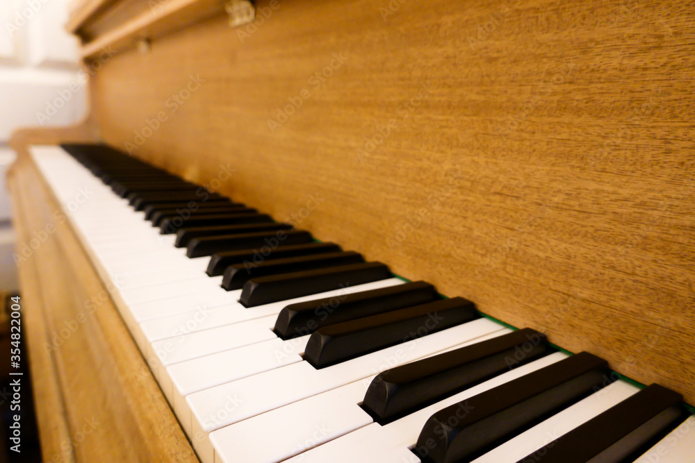 Wooden brown grand piano instrument for classical song and jazz music included black and white keys vintage style decoration in entertainment home studio perspective view Wooden brown grand piano instrument for classical song and jazz music included black and white keys vintage style decoration in entertainment home studio perspective view