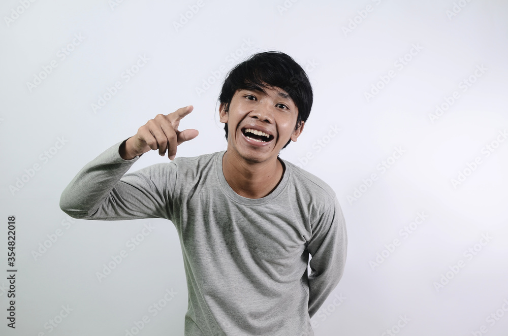 Asian man with laugh face. Asian man in a gray t-shirt isolated on a white background Asian man with laugh face. Asian man in a gray t-shirt isolated on a white background