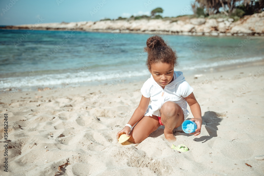 Adorable happy smiling little girl on beach vacation. Adorable happy smiling little girl on beach vacation.