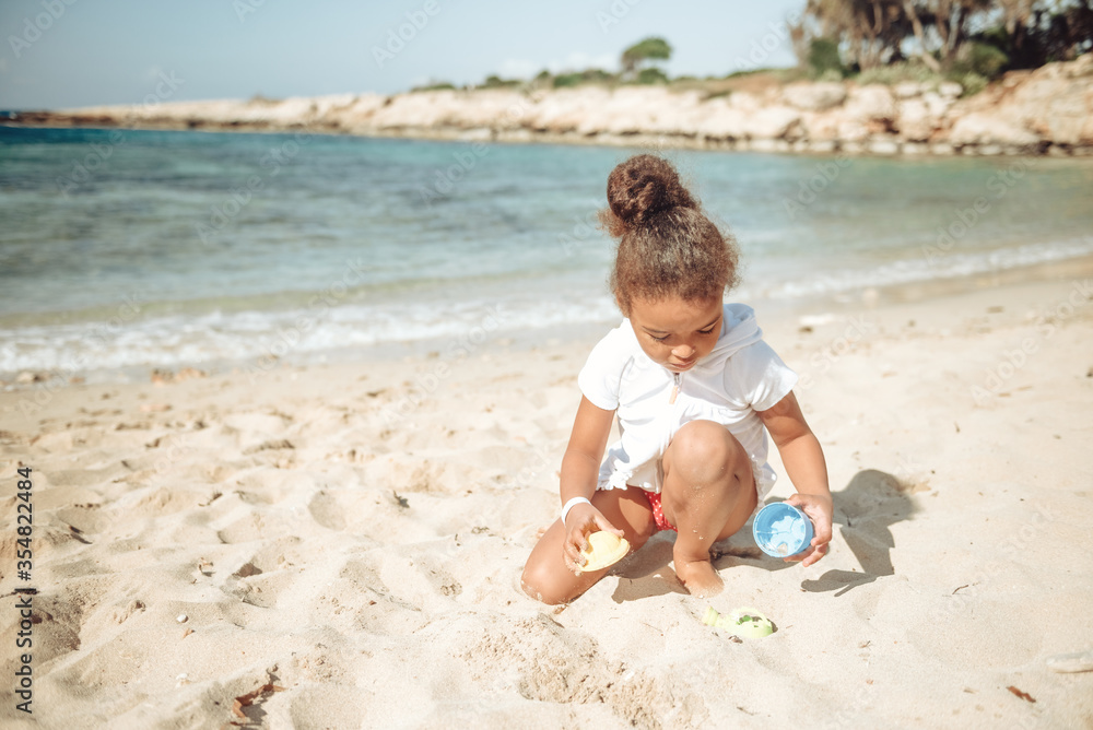 Adorable happy smiling little girl on beach vacation. Adorable happy smiling little girl on beach vacation.