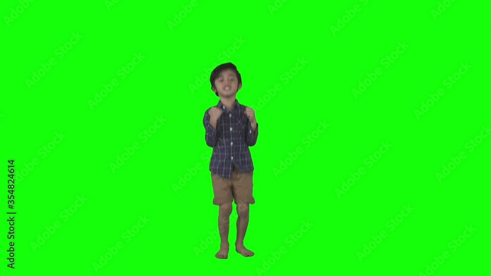 Cute boy looks happy while jumping in the studio Cute boy looks happy while jumping in the studio