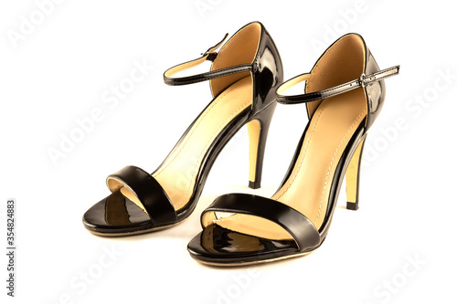 Women's black leather patent high-heeled sandals, isolated on a white background. Side view