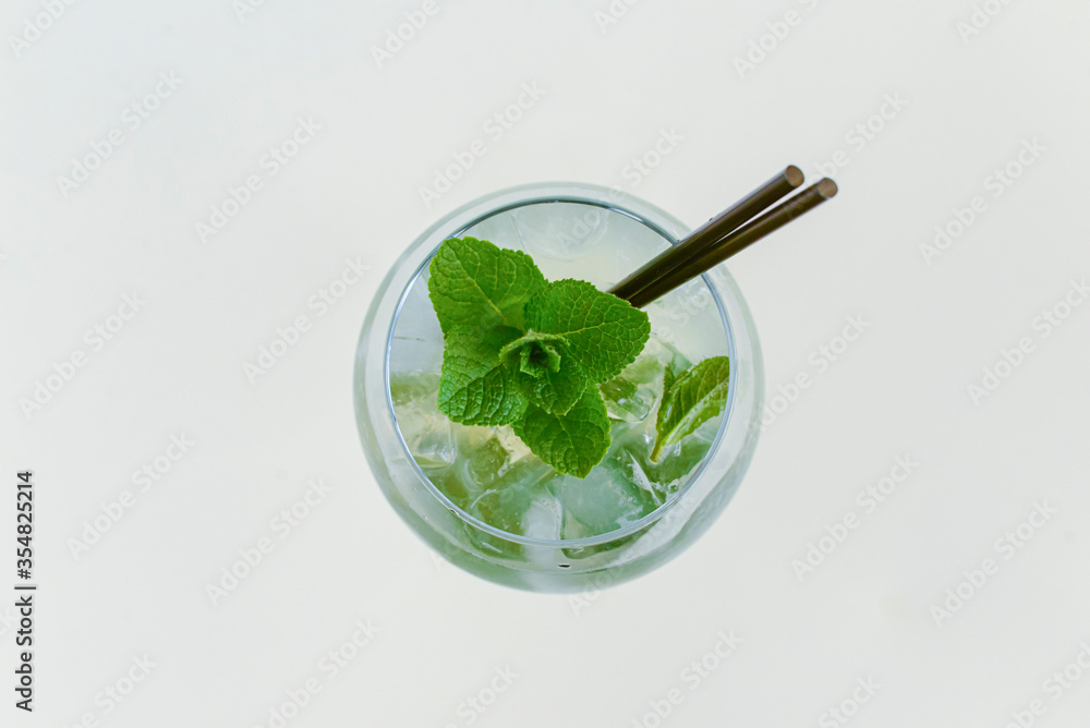 Cold summer alcohol cocktail with ice and orange in a tall wine glass isolated on white background. Cold summer alcohol cocktail with ice and orange in a tall wine glass isolated on white background.