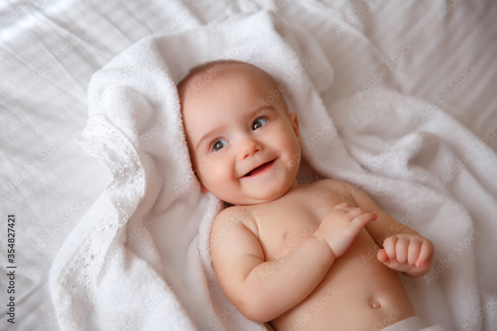 baby in a diaper
lying on the bed at home smiling baby in a diaper
lying on the bed at home smiling