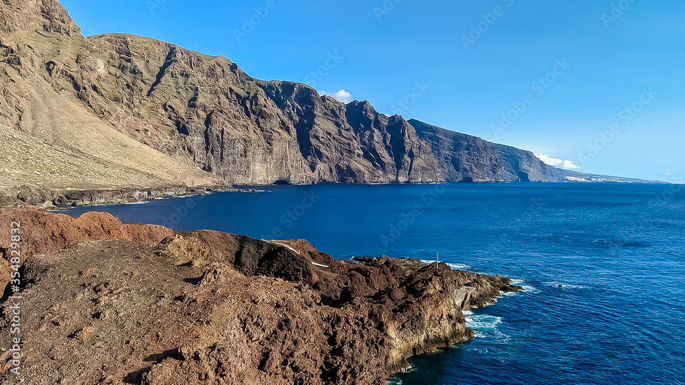 Beautiful large cliffs on the coast and the blue ocean.