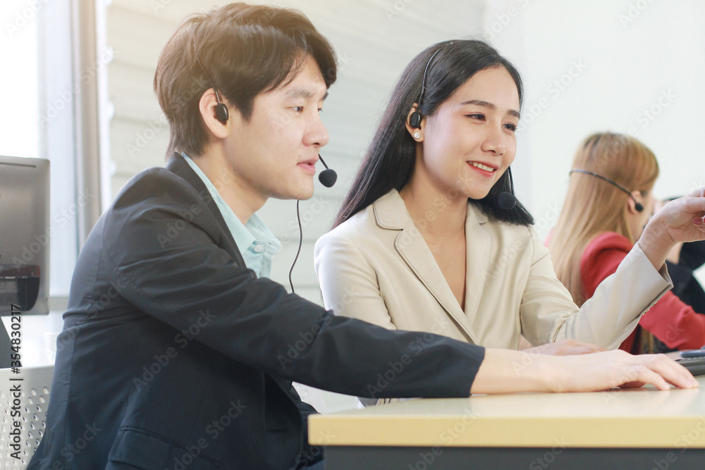 Business Call Center and technical Support staff or receptionist phone operator Discussing and working for teamwork with computer. Asian customer support team. Business Call Center and technical Support staff or receptionist phone operator Discussing and working for teamwork with computer. Asian customer support team.