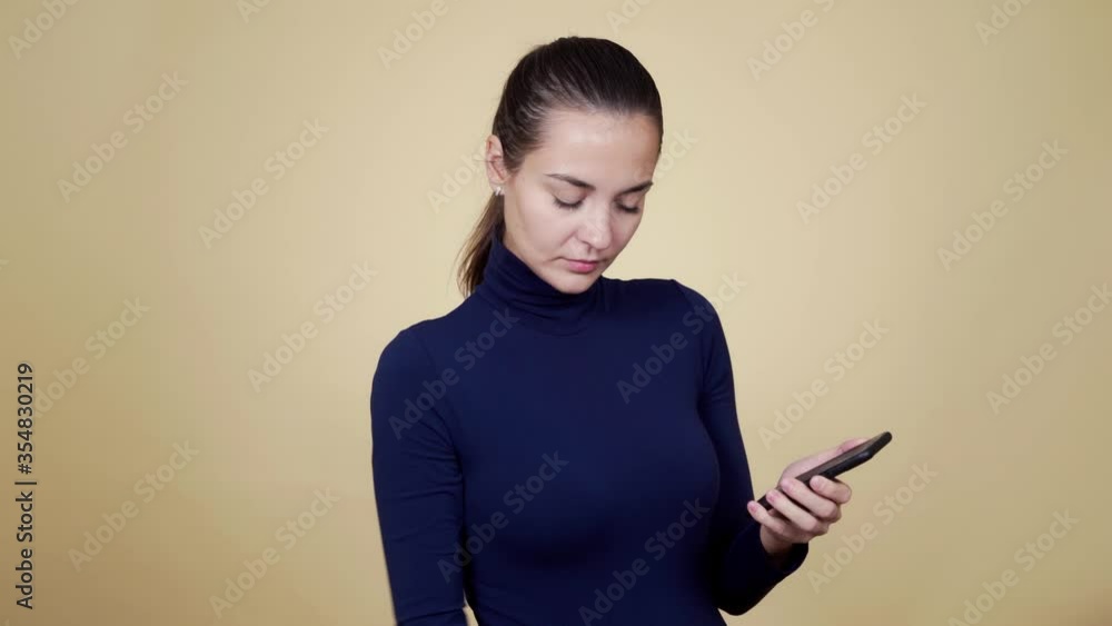 Portrait of woman sprays disinfectant on phone screen, wipes and disinfects it Portrait of woman sprays disinfectant on phone screen, wipes and disinfects it