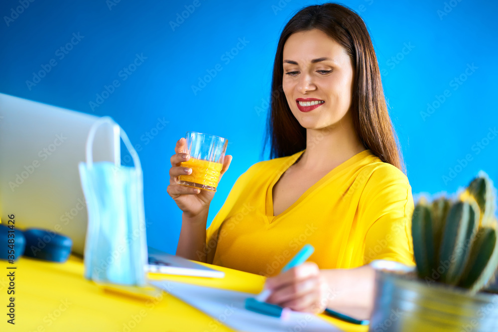 woman drinks juice and works during quarantine woman drinks juice and works during quarantine
