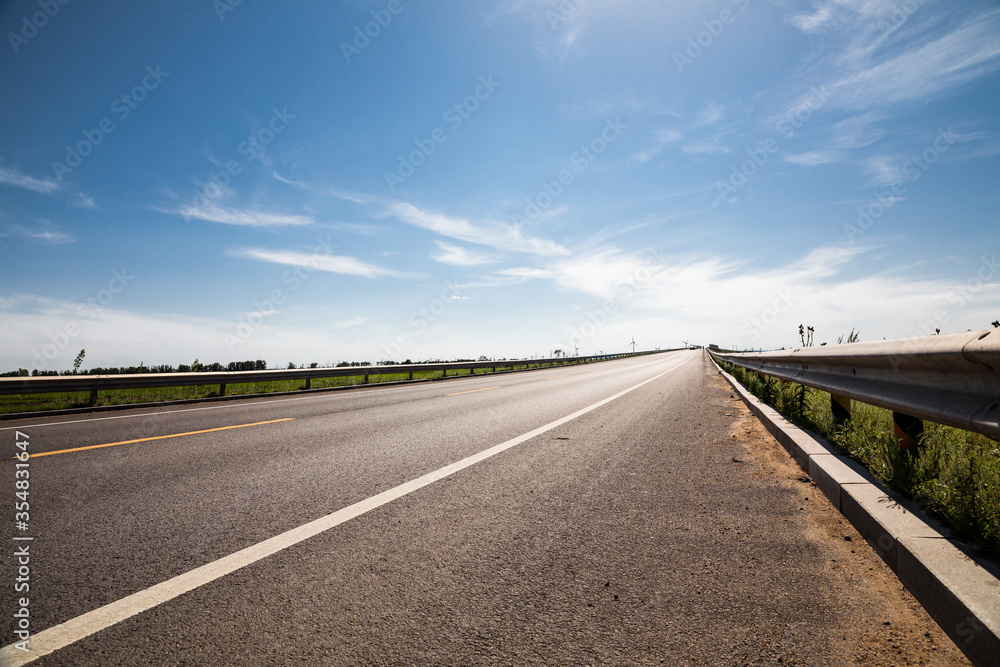 Fototapeta premium Picturesque country road and clear sky
