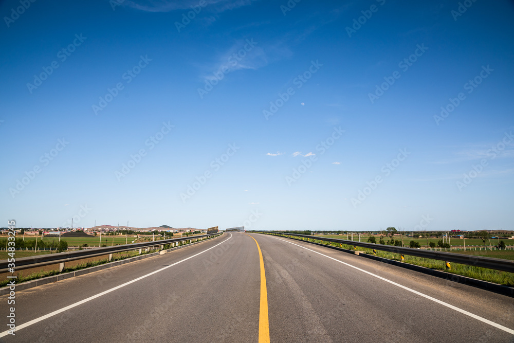 Fototapeta premium Picturesque country road and clear sky