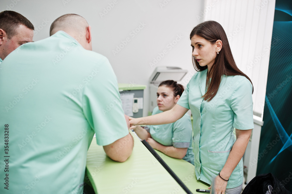 Obraz premium Medical theme. Group of doctors meeting at reception of diagnostic center in hospital.