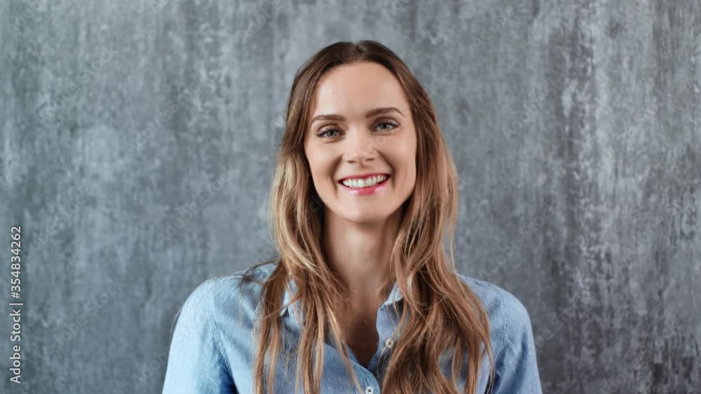 Portrait of joyful woman smiling with open mouth isolated. Medium close up shot on 4k RED camera Portrait of joyful woman smiling with open mouth isolated. Medium close up shot on 4k RED camera