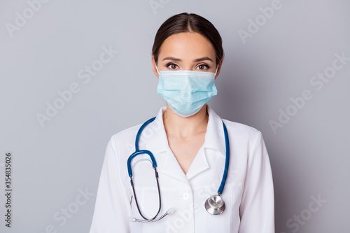 Photo of attractive virologist doc lady experienced skilled professional listen patient wear facial cotton mask medical uniform lab coat stethoscope isolated grey background
