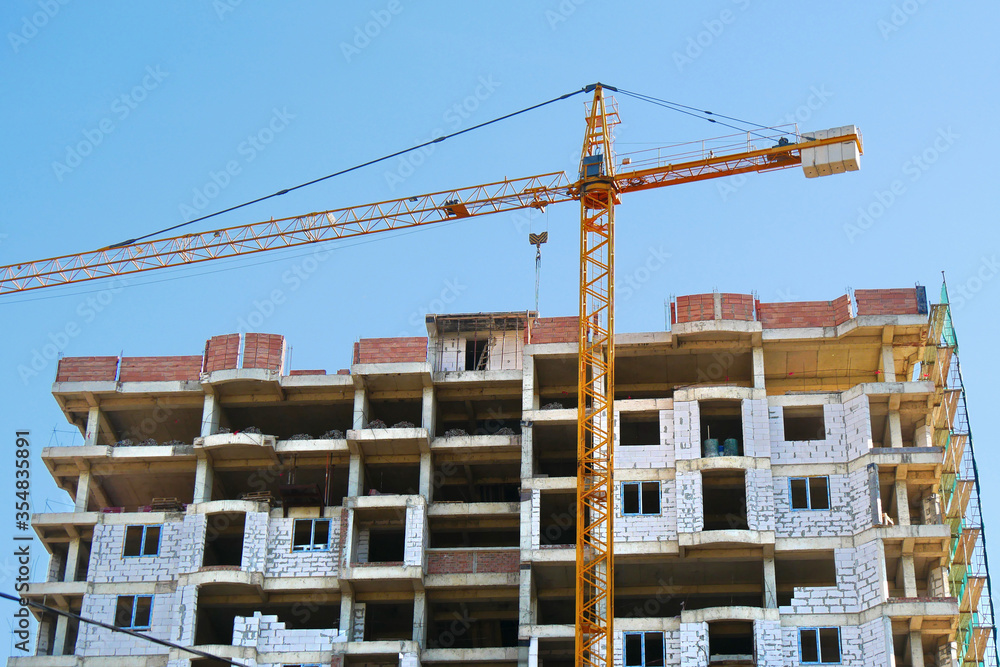 Crane. Self-erection crane near concrete building. Construction site. Crane. Self-erection crane near concrete building. Construction site.