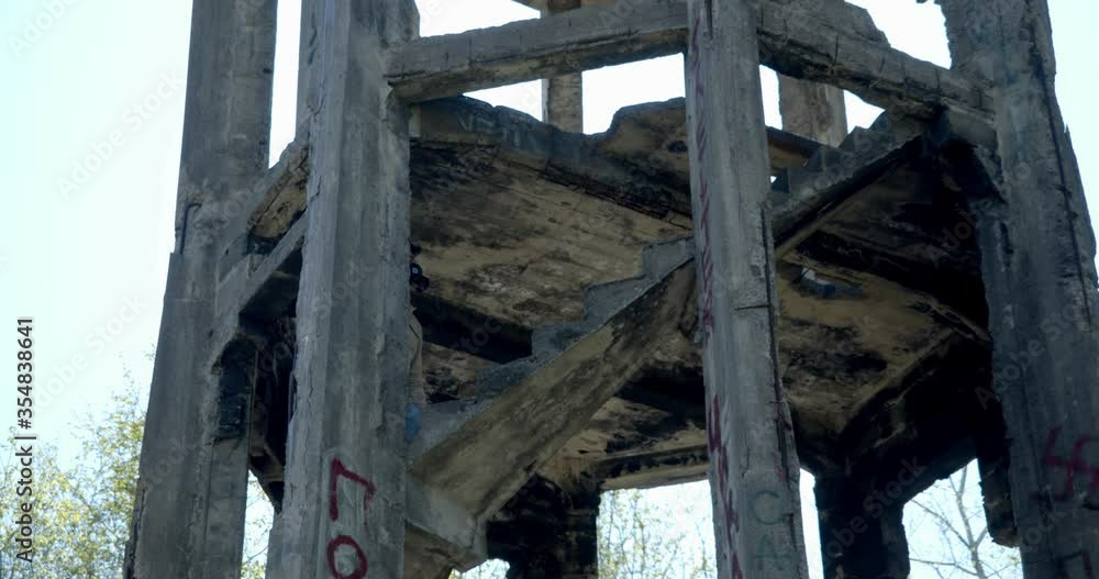 general plan a man in a black respirator descends the stairs of a destroyed house. a sense of the Apocalypse general plan a man in a black respirator descends the stairs of a destroyed house. a sense of the Apocalypse