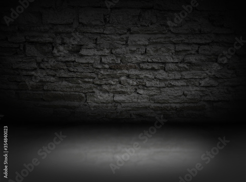 A backdrop of an old limestone empty room or prison cell with a concrete floor