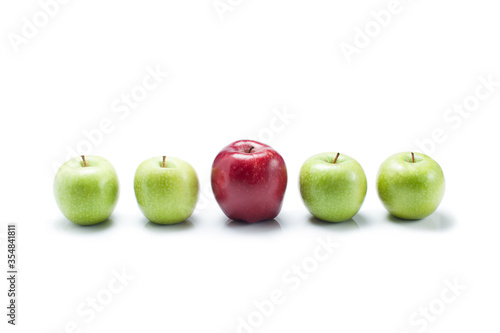 Valokuva one red apple and many green