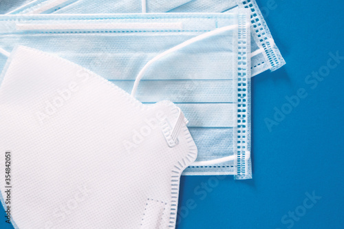 New protective blue medical face mask on a blue background. The concept of safety and prevention during an epidemic of viral infection COVID-19