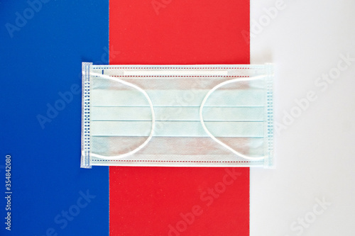 Close-up of protective medical masks and face masks on the background of the country's flag. Concept of protection during the COVID-19 virus infection epidemic