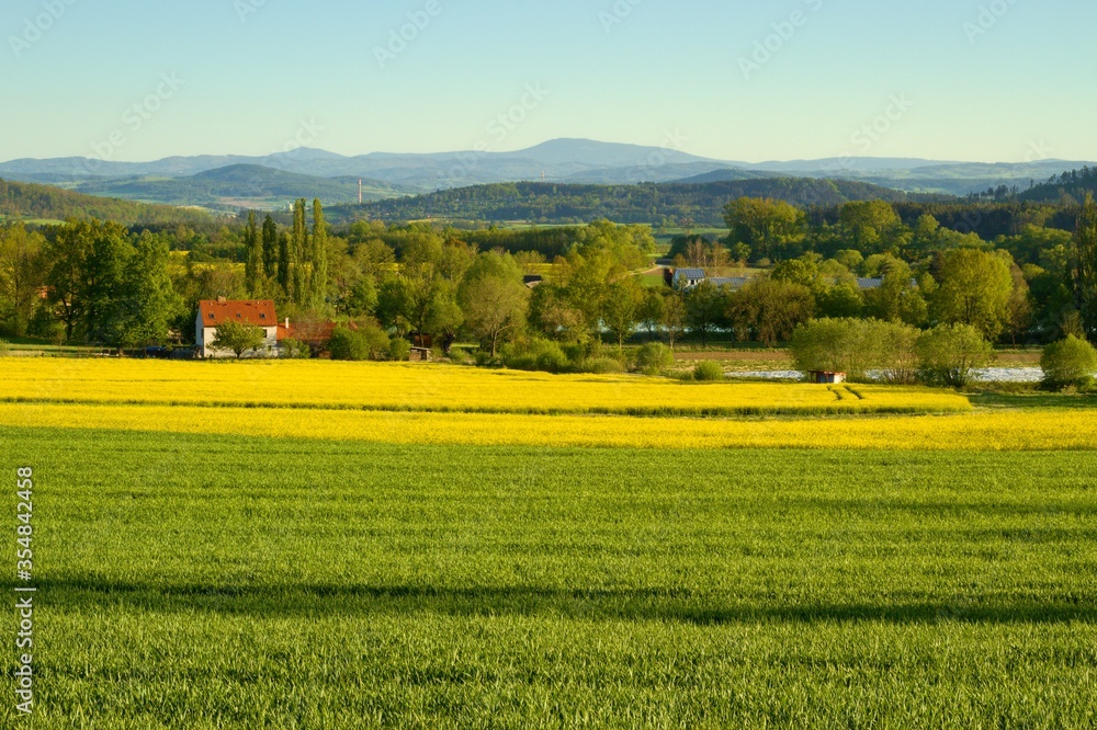 Typical panoramic preserved spring rural country landscape with small village of South Bohemia, Czech Republic