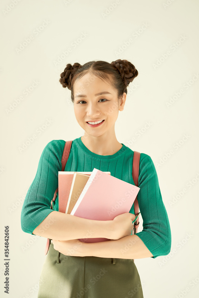 Portrait of a gorgeous young student girl holding exercise books. Portrait of a gorgeous young student girl holding exercise books.