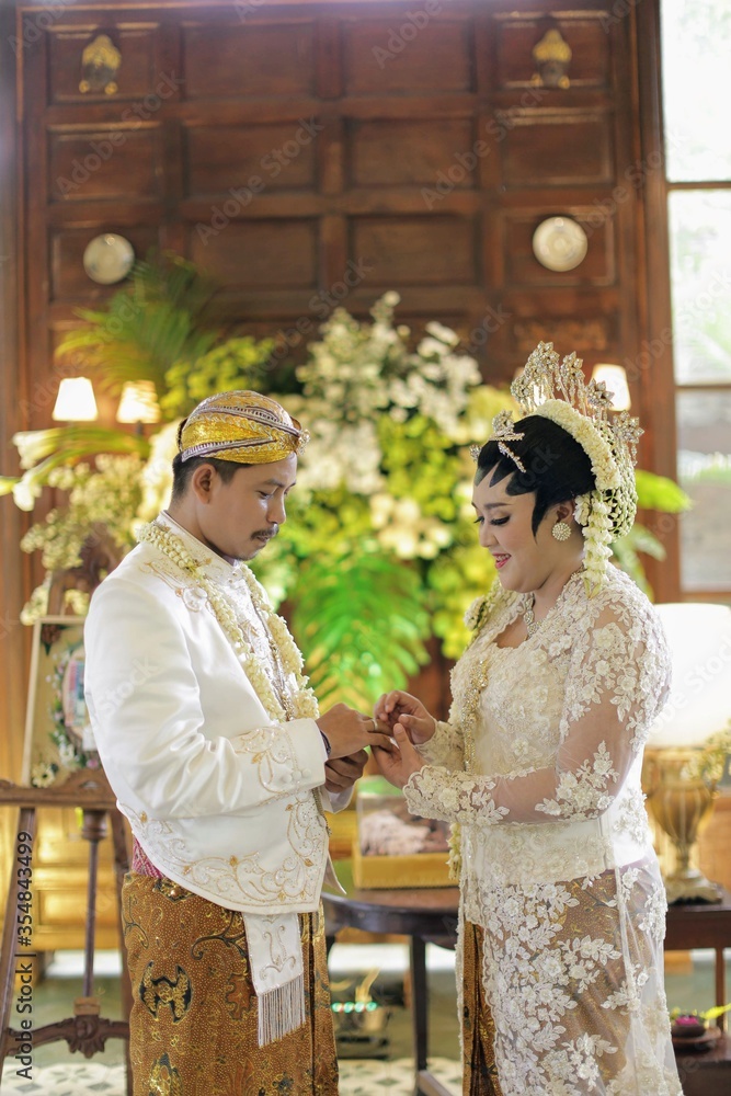Masang cincin ceremony is javanese groom puts a ring on the bride on Indonesian traditional wedding.
