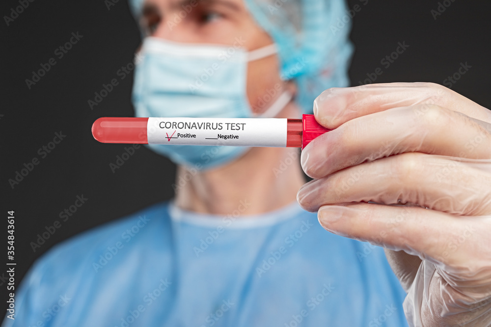 Doctor with coronavirus test tube with positive result Doctor with coronavirus test tube with positive result