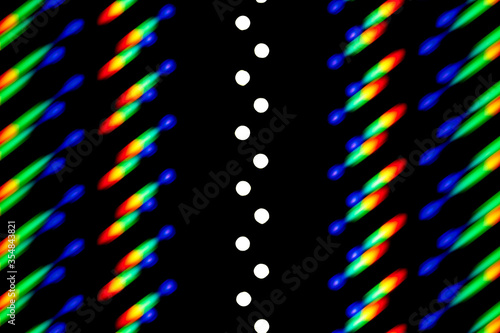 Photo of a diffraction pattern from a line of LEDs. Image was obtained using a diffraction grating. Illustrates the distribution of energy over wavelengths in the emission spectrum of the LED