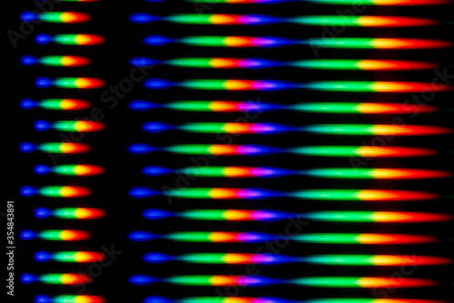 Photo of a diffraction pattern from a line of LEDs. Image was obtained using a diffraction grating. Illustrates the distribution of energy over wavelengths in the emission spectrum of the LED