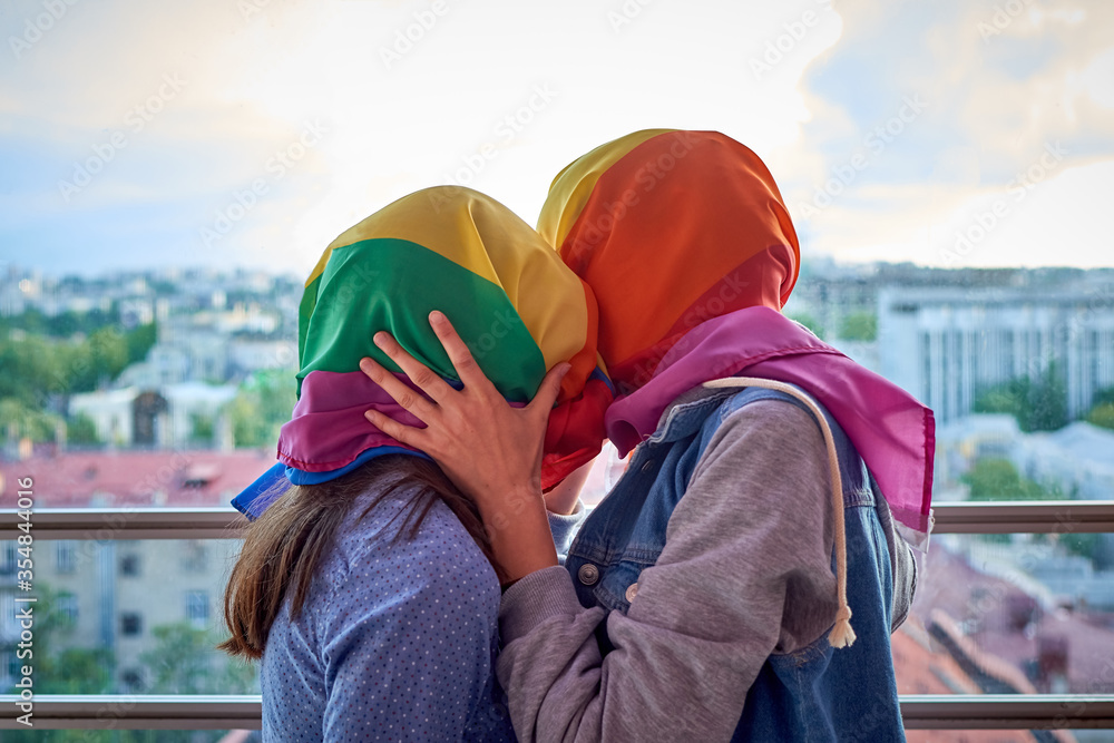 Zdjęcie Stock Lesbian Couple Kissing Through A Rainbow Flag Covering