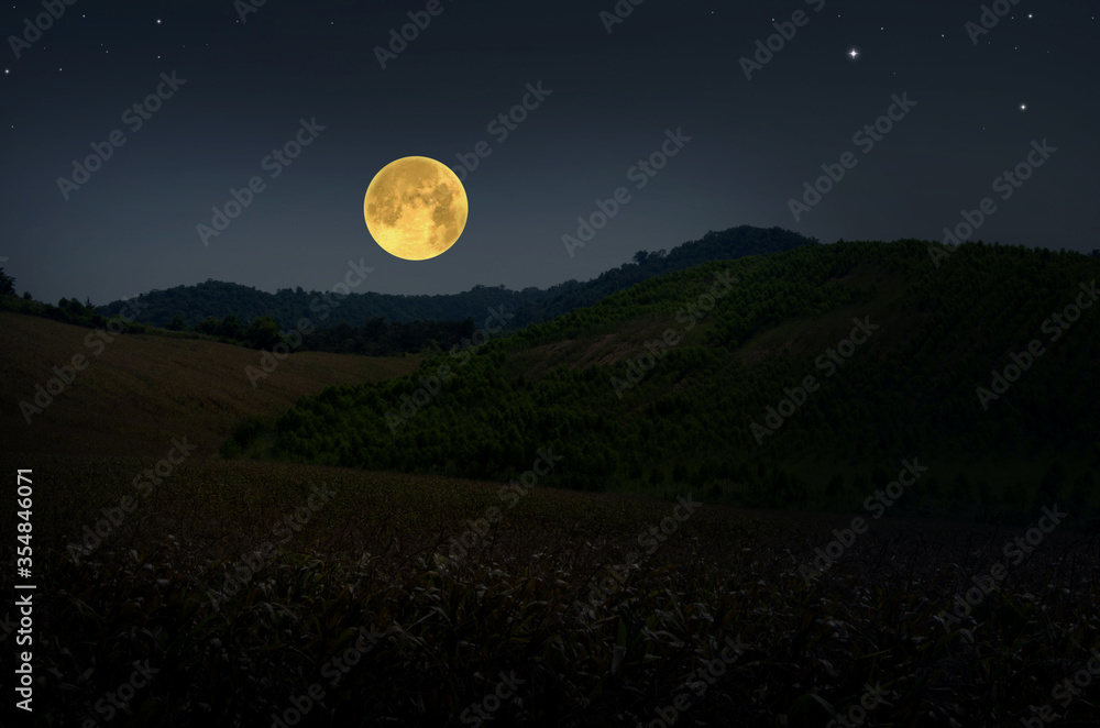 Big full moon over the valley and hills