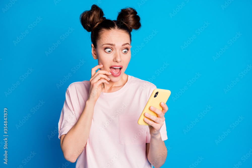 Close-up portrait of her she nice-looking attractive pretty lovely worried nervous girl using cell 5g app reading fake scary post news isolated on bright vivid shine vibrant blue color background Close-up portrait of her she nice-looking attractive pretty lovely worried nervous girl using cell 5g app reading fake scary post news isolated on bright vivid shine vibrant blue color background
