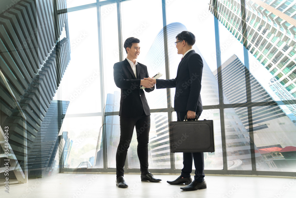 Businesspeople shaking hands in the office finishing the successful meeting, concept teamwork coordination Businesspeople shaking hands in the office finishing the successful meeting, concept teamwork coordination