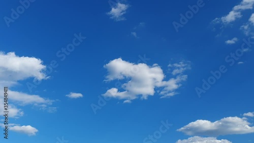 white clouds disappear in the hot sun on blue sky. Time-lapse motion clouds, blue sky background and sun