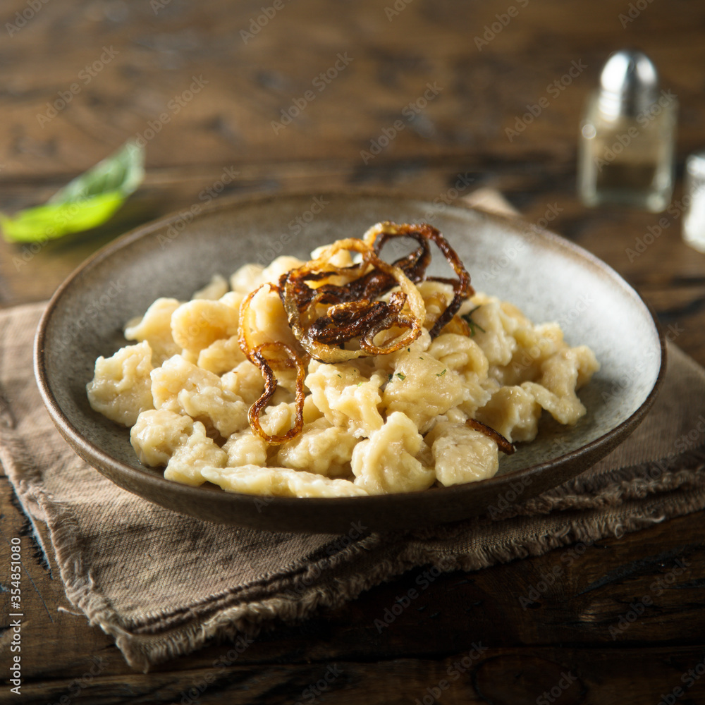 Traditional German noodles with cheese and fried onion Traditional German noodles with cheese and fried onion