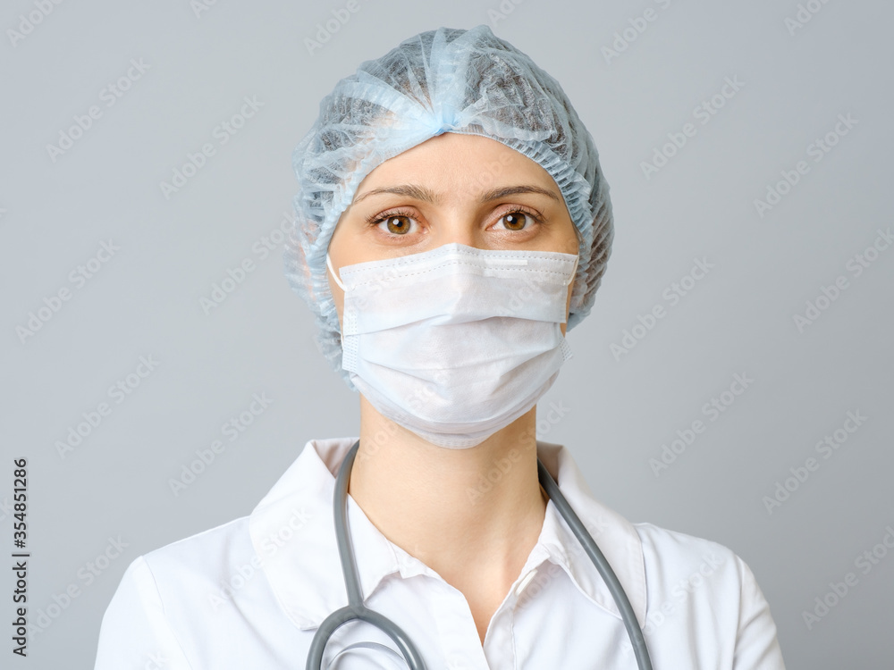 Portrait female doctor in protective medical mask and cap Portrait female doctor in protective medical mask and cap