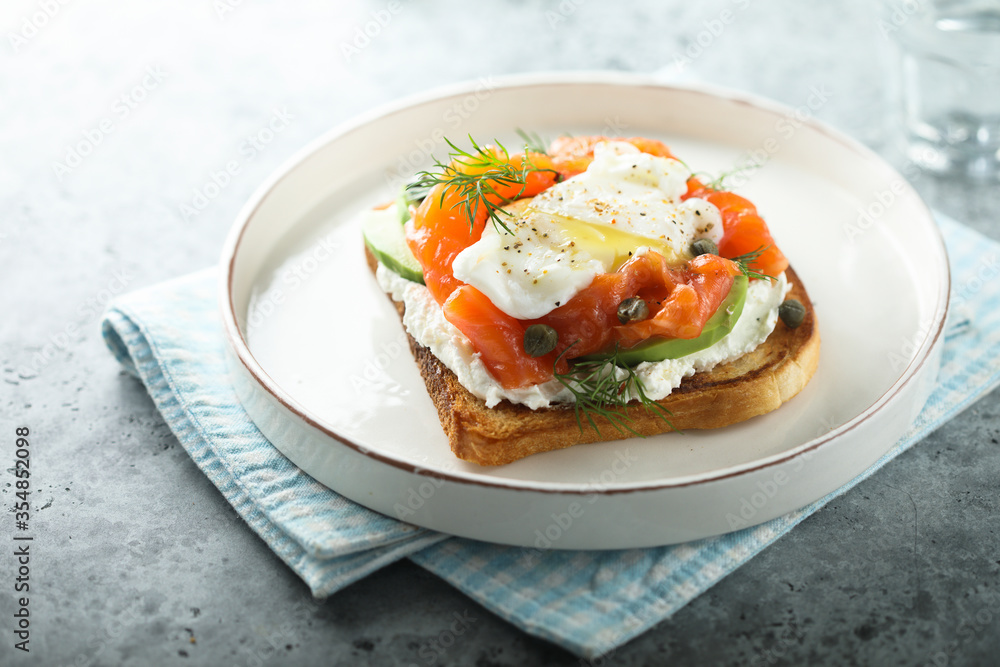 Poached egg with salmon and avocado on toast Poached egg with salmon and avocado on toast