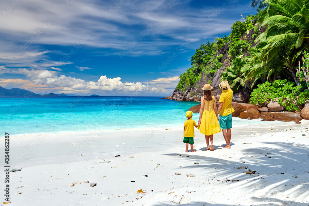 Family with three year old boy on beach. Seychelles, Mahe.