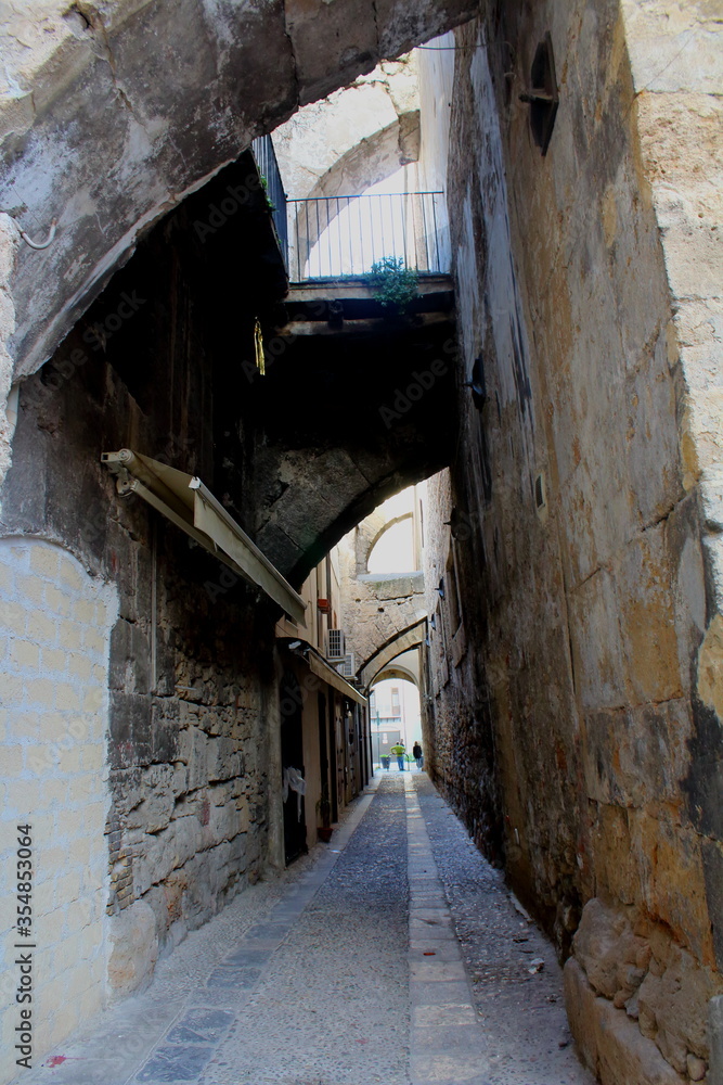 evocative image of an ancient street in the historic center of Palermo in Italy
