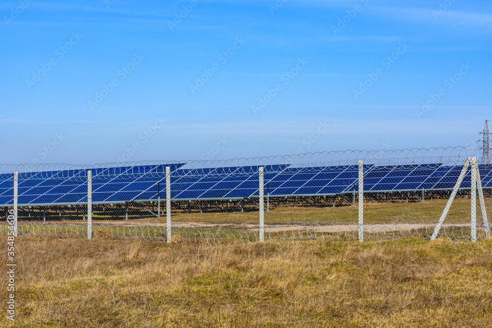 Many solar panels in a field. Clean energy. Ecological concept Many solar panels in a field. Clean energy. Ecological concept