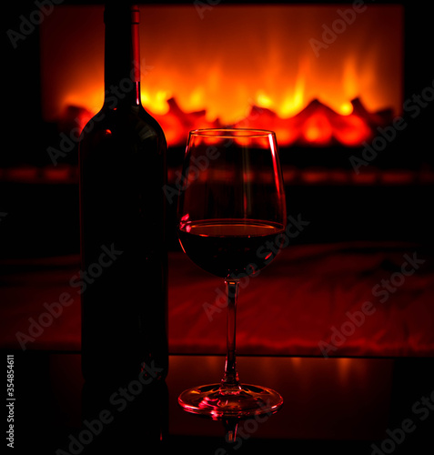 glass of wine on the table with fire