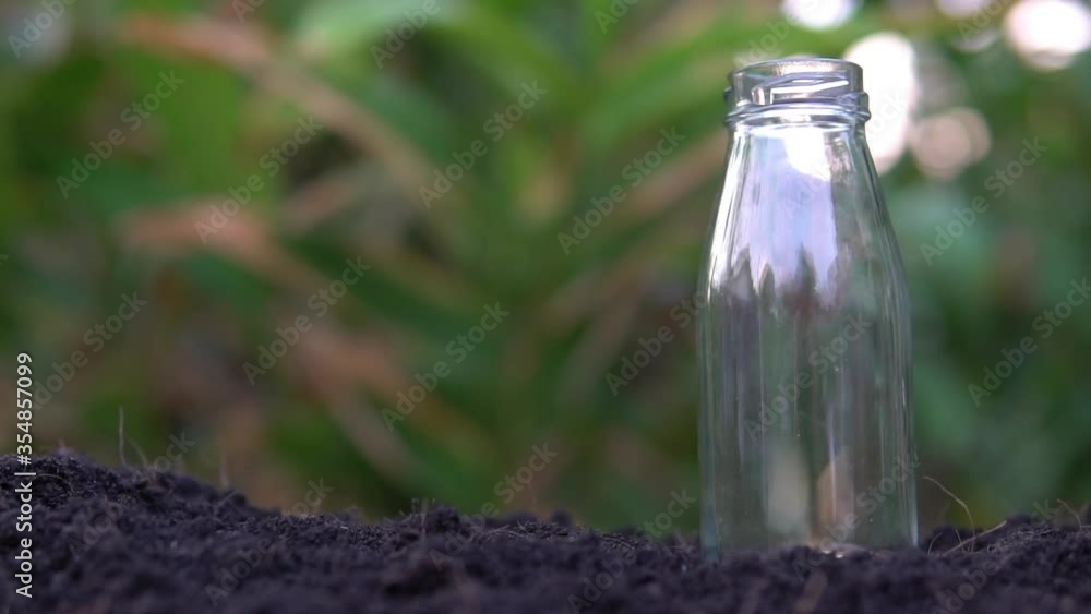 Slow motion Put the coin into the glass bottle,saving money concept Slow motion Put the coin into the glass bottle,saving money concept